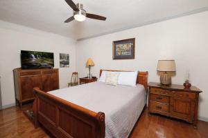 a bedroom with a bed and a flat screen tv at A River Runs Through It in Sevierville