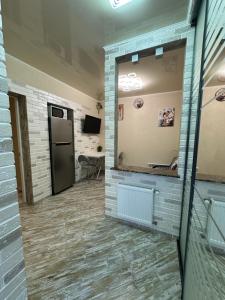 a hallway with a mirror and a door in a room at Апартаменти Dvoryanskay in Odesa