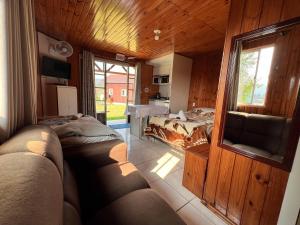 a living room with a couch and a bed in it at Pousada da Z in Urubici
