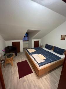 a bedroom with a large bed and a table at Alt Neel in Schwalmtal