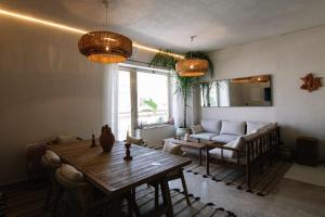 a living room with a table and a couch at Taga Suites in Catania
