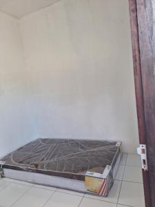 a bed sitting in a corner of a room at Asry Homestay in Sekongkang