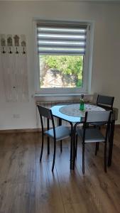 a table and chairs in a room with a window at Apartament z pianinem in Grajewo +11 photos
