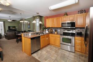 a kitchen with wooden cabinets and stainless steel appliances at Still Waters in Pigeon Forge