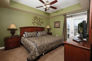 a bedroom with a bed and a flat screen tv at Still Waters in Pigeon Forge
