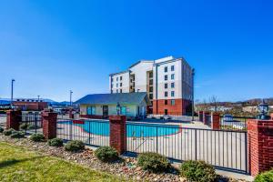 a building with a swimming pool in front of a building at Still Waters in Pigeon Forge