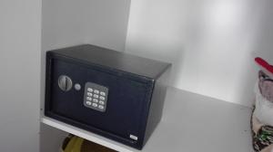 a black microwave oven sitting on a wall at Apanemia Rooms in Kini