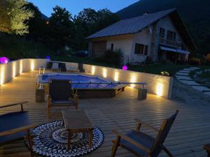 a patio with a pool and chairs and lights at CHALET DON PAPA in Saint-Martin-Vésubie