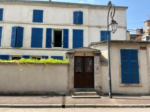 a building with blue shuttered windows and a door at La Maison Majorelle in Bar-sur-Aube +10 photos