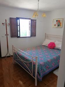 a bedroom with a bed in a room with a window at Villa Cantinho dos Avós in Baião +33 photos