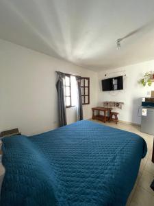 a bedroom with a blue bed in a room at Monoambiente Tilcara in Tilcara