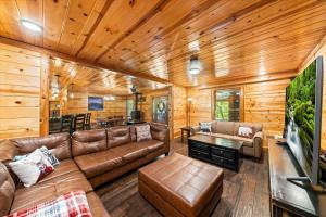 a living room with a couch and a tv at Tequila Moon in Sevierville