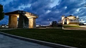 a building in a park with a grassy field at Monte da Aferrada - CASAS DA VILA in Alpalhão