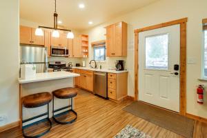 a kitchen with a counter and stools in it at Fishermans Cabin in Soldotna Near Kenai River! in Soldotna
