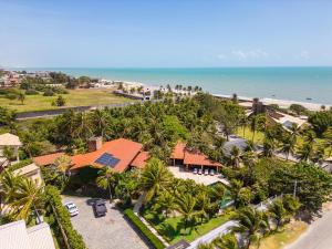 an aerial view of a resort with palm trees and the ocean at Mansao Santa Rita in Cumbuco