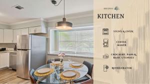 a kitchen with a table with chairs and a refrigerator at Amazing 4BR 2BA Winter Home with Pool & Game-Movie Room in Texas City