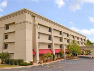 a large building with a parking lot in front of it at Baymont by Wyndham Kalamazoo West in Kalamazoo