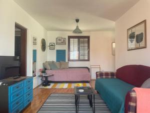 a living room with a couch and a bed at Pier Apartments in Krašići