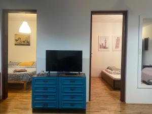 a room with a blue dresser with a television on it at Pier Apartments in Krašići +28 photos