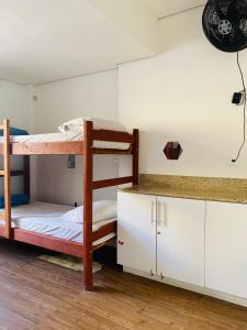 a room with two bunk beds and a counter at Trem Chic in Belo Horizonte