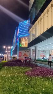 a person walking in front of a building at night at Five BHK Abode in Golf City Lucknow in Nalmatha