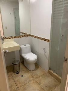 a bathroom with a toilet and a sink and a mirror at Departamento de 04 dormitorios in Lima +15 photos