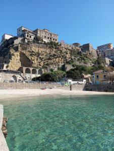 a view of a beach with buildings on a mountain at Palazzo Sardanelli in Pizzo