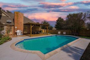 a swimming pool in the backyard of a house at The Prestige Poolside Escape - 5BR with Cinema & Gaming in DeSoto