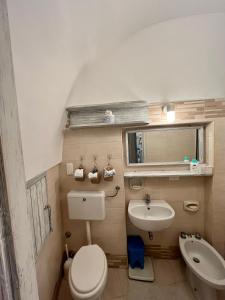 a small bathroom with a toilet and a sink at Pietre di Mare in Castro di Lecce