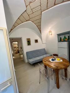 a living room with a table and a couch at Pietre di Mare in Castro di Lecce +9 photos