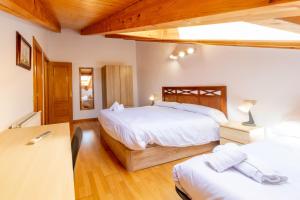 a bedroom with two beds and a desk in it at RENOVADO - Ático Plaza Herradores, céntrico y con Wifi in Soria