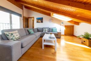a living room with a couch and a table at RENOVADO - Ático Plaza Herradores, céntrico y con Wifi in Soria