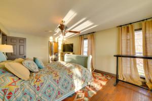 a bedroom with a bed and a ceiling fan at Peaceful Big Sandy Home with Deck on Kentucky Lake! in Big Sandy