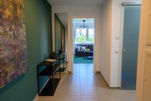 a hallway with green walls and a painting on the wall at Ferienwohnung in Warburg in Warburg