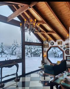 a living room with a table and a large window at Spectra Lodge Boutique Hotel in Malalcahuello
