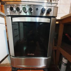 a stove top oven sitting in a kitchen at Remodelada Cabaña Antoleo a metros de Lago Vichuquén in Vichuquén