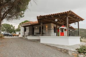 a house with a gazebo in front of it at On the hill Residence in Makrikhórion