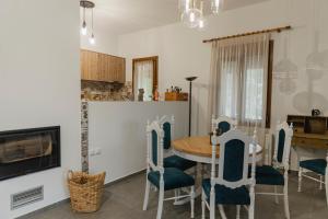 a kitchen and dining room with a table and chairs at On the hill Residence in Makrikhórion