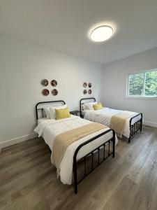 a bedroom with two beds and a window at Luxury Lakefront Escape W Games Room in Stokes Bay