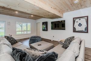 a living room with a couch and a tv at Luxury Lakefront Escape W Games Room in Stokes Bay