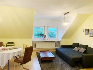 a living room with a couch and a table at OTTOC Ferienwohnung in Üxheim