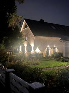a house with lights on the side of it at night at Pension Musa in Hamburg