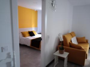 una camera da letto con un letto e un divano di APARTAMENTO Sanin 2 a Lumbrales
