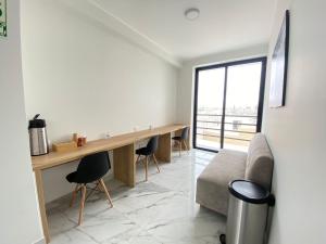 a living room with a desk and a couch at Costanera Hotel in San Juan