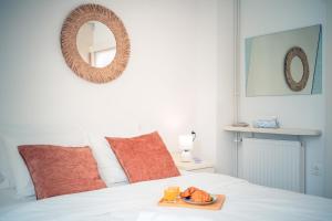 a tray of food on a bed with a mirror at Pharos Sunset - Stari Grad Center in Stari Grad