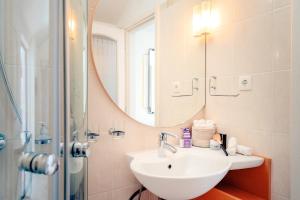 a bathroom with a sink and a mirror at Pharos Sunset - Stari Grad Center in Stari Grad +34 photos