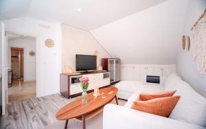 a living room with a white couch and a table at Pharos Sunset - Stari Grad Center in Stari Grad