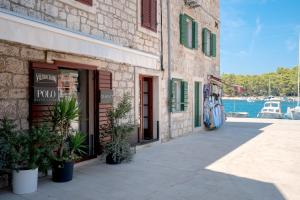 a building on a street next to the water at Pharos Sunset - Stari Grad Center in Stari Grad