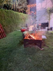 a grill in the grass in a yard at ValZur Hospedaje-Habitación Acacias in Villa del Carbón +47 photos