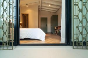 Voodi või voodid majutusasutuse Hotel Boutique Roomzz Laureles toas